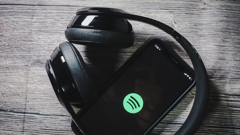 An iphone 11 screen showing spotify icon with beats earphone, perfect for listening musics on the go