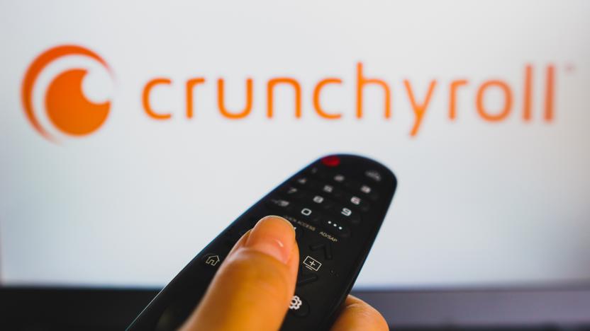 BRAZIL - 2022/05/10: In this photo illustration, a hand holding a TV remote control in front of the Crunchyroll logo on a TV screen. (Photo Illustration by Rafael Henrique/SOPA Images/LightRocket via Getty Images)