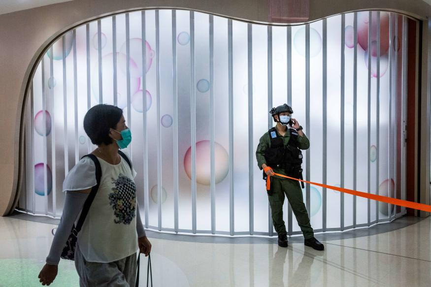 A riot police officer stands guard after a protest by district councillors at a mall in Yuen Long in Hong Kong on July 19, 2020, against a mob attack by suspected triad gang members inside the Yuen Long train station on July 21, 2019. (Photo by ISAAC LAWRENCE / AFP) (Photo by ISAAC LAWRENCE/AFP via Getty Images)