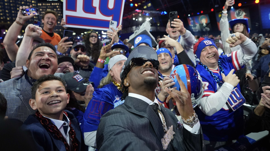 Associated Press - LSU wide receiver Malik Nabers celebrates with fans after being chosen by the New York Giants with the sixth overall pick during the first round of the NFL football draft, Thursday, April 25, 2024, in Detroit. (AP Photo/Paul Sancya)