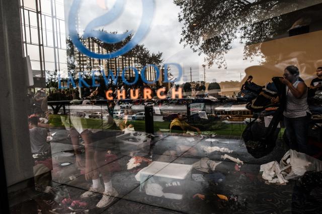 Volunteers take donations at the Lakewood Church in Houston.  (Joseph Rushmore for HuffPost)