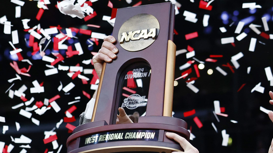 Getty Images - LOS ANGELES, CALIFORNIA - MARCH 30: Head coach Nate Oats of the Alabama Crimson Tide celebrates with the trophy after defeating the Clemson Tigers 89-82 in the Elite 8 round of the NCAA Men's Basketball Tournament at Crypto.com Arena on March 30, 2024 in Los Angeles, California. (Photo by Ronald Martinez/Getty Images)