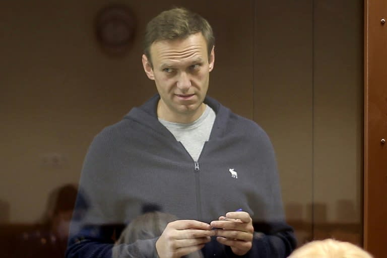 Arrested in court, Navalny mocks Putin and chases fans