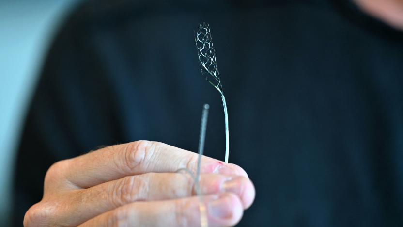 CEO & Founder of, Synchron, Thomas Oxley, holds a stentrode in his office on August 9, 2023, in New York. Synchron got permission from US authorities in 2021 to test its implant and has on nine people with Amyotrophic Lateral Sclerosis. The implant allows the use of messaging apps and browsing online using only eye movements and thoughts. Unlike other implants, it does not need invasive surgery. Oxley thinks the technology, known as brain-computer interface, is now at a "turning point." The industry must aim to make the implants widely accessible, he told AFP. (Photo by ANGELA WEISS / AFP) (Photo by ANGELA WEISS/AFP via Getty Images)