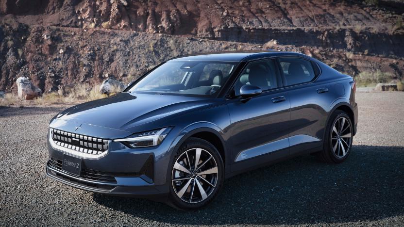 The Polestar 2 EV parked on a dirt and gravel road with a rocky cliff in the background.