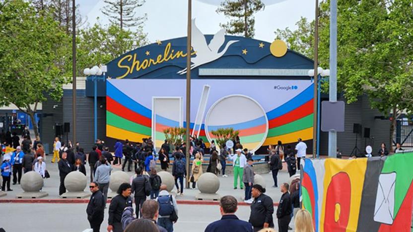 A scene from outside of the shoreline theater where Google I/O is being held. People are seen strolling along the walkways.