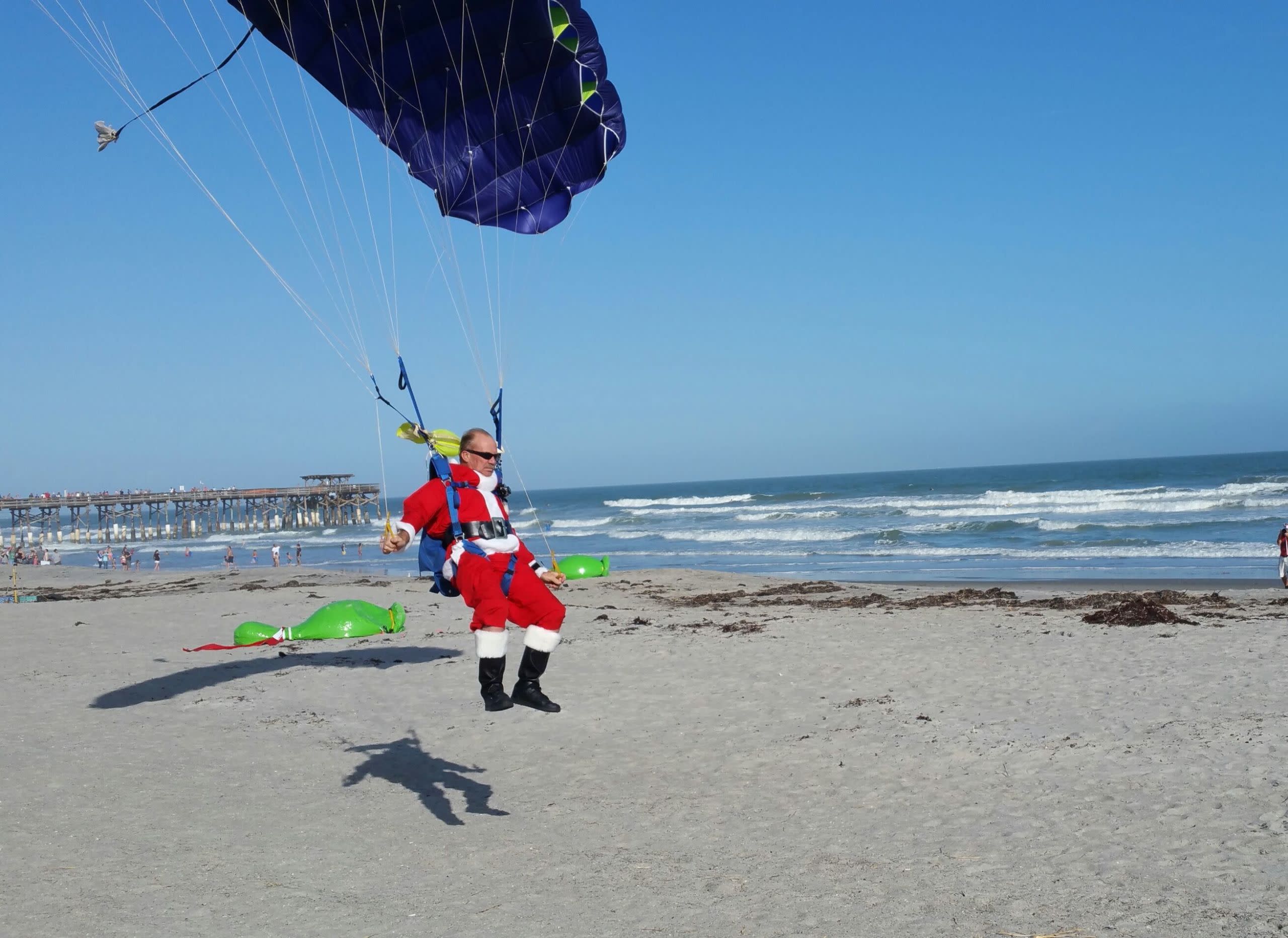 Just a Bunch of Santas Skydiving Onto a Beach