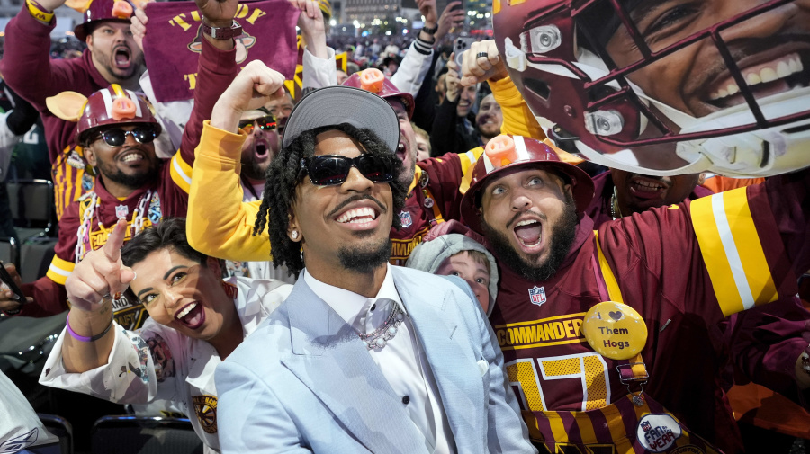 Associated Press - LSU quarterback Jayden Daniels celebrates with fans after being chosen by the Washington Commanders with the second overall pick during the first round of the NFL football draft, Thursday, April 25, 2024, in Detroit. (AP Photo/Paul Sancya)