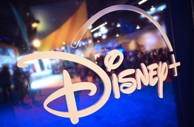 Fans are reflected in Disney+ logo during the Walt Disney D23 Expo in Anaheim, California on September 9, 2022. (Photo by Patrick T. FALLON / AFP) (Photo by PATRICK T. FALLON/AFP via Getty Images)