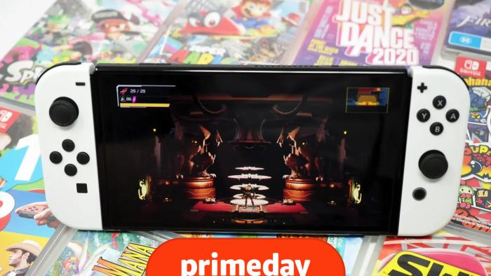 A white Nintendo Switch OLED sits on a stack of Nintendo Switch game cases, with the game Metroid Dread displayed on screen.