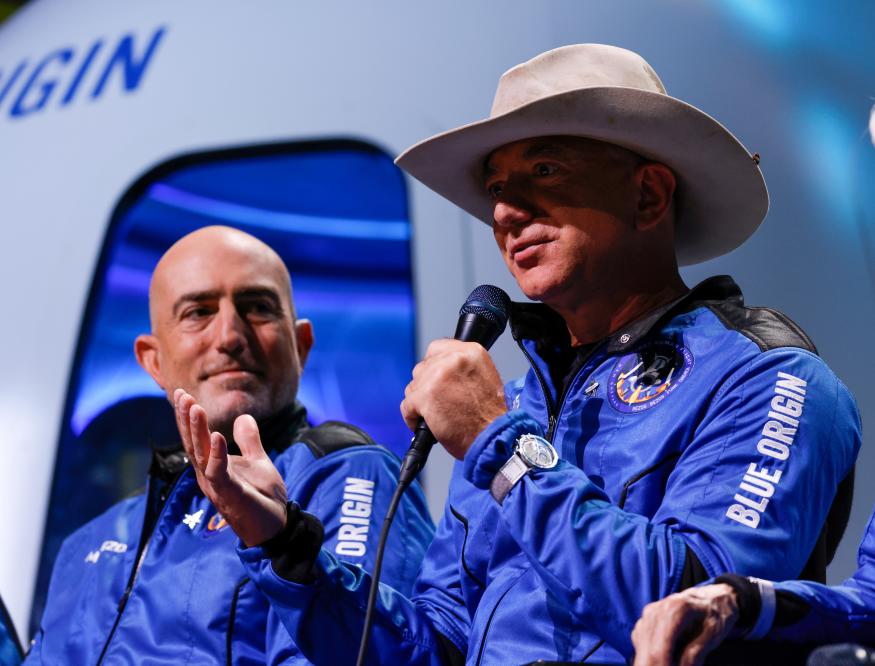 Billionaire American businessman Jeff Bezos speaks with his brother Mark at a post-launch press conference after they flew on Blue Origin's inaugural flight to the edge of space, in the nearby town of Van Horn, Texas, U.S., July 20, 2021.   REUTERS/Joe Skipper