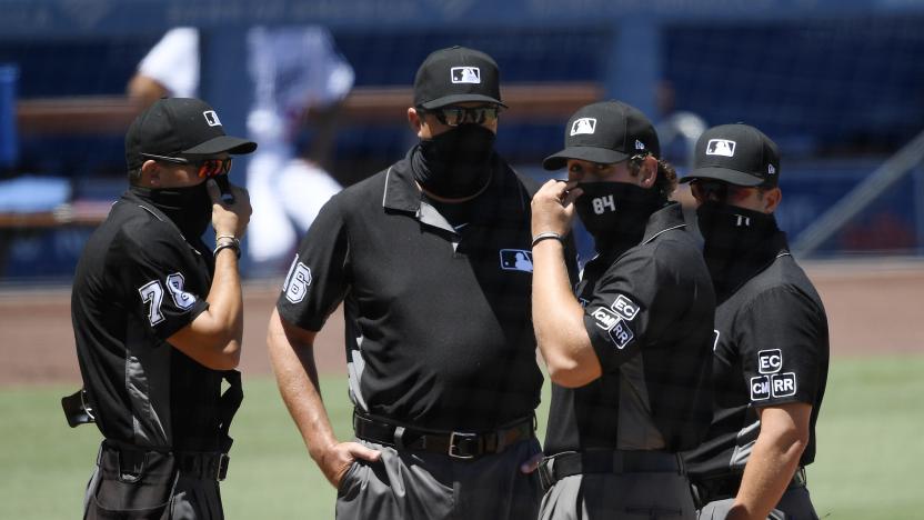 LOS ANGELES, CA - AUGUST 09: Major League umpires wearing face mask prepare to call the game between the San Francisco Giants and Los Angeles Dodgers at Dodger Stadium on August 9, 2020 in Los Angeles, California. The 2020 regular season has been shortened to 60 games and fans are not allowed in the stadium due to the COVID-19 pandemic. (Photo by Kevork Djansezian/Getty Images)