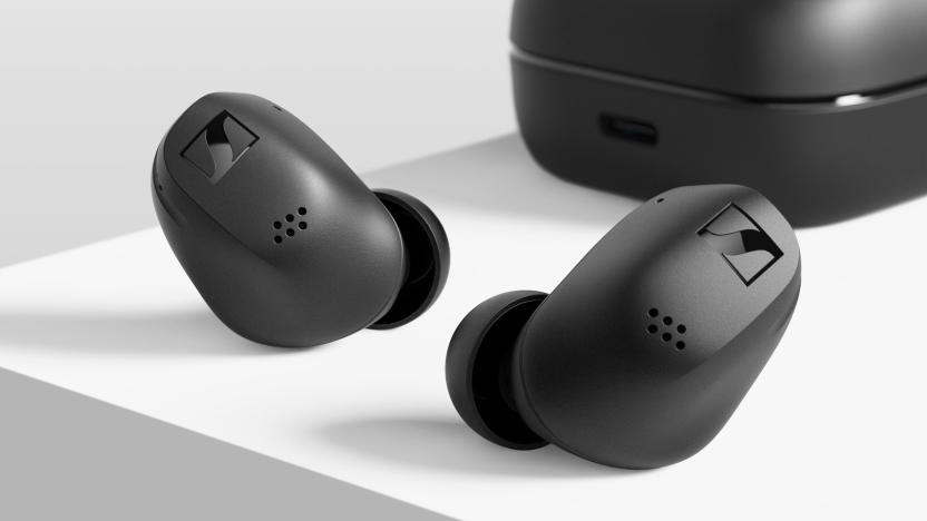 Sennheiser Accentum True Wireless earbuds in black sitting on a white surface with the charging case in the background.