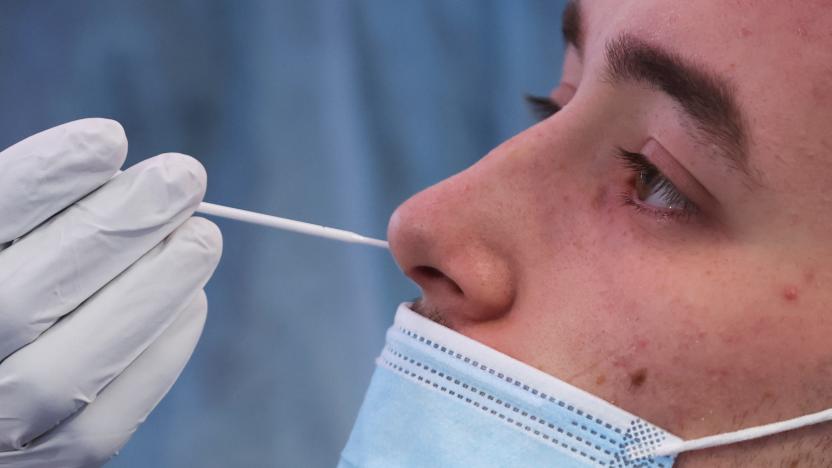 A healthcare worker takes a swab sample from a man to test for the coronavirus disease (COVID-19) at a COVID-19 testing centre in Brussels, Belgium, January 27, 2022. REUTERS/Yves Herman