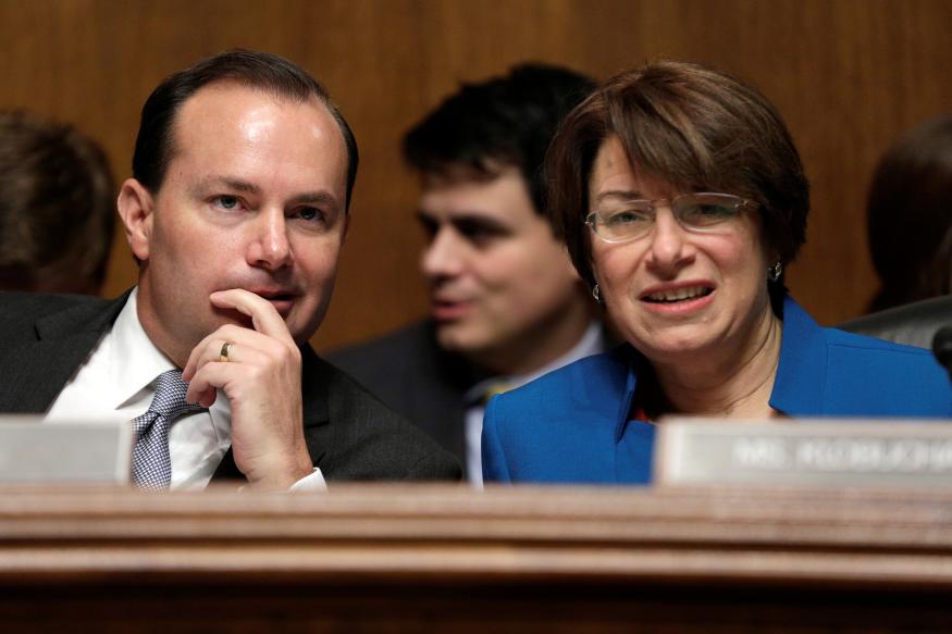 Chairman of the Senate Judiciary Committee Antitrust Subcommittee Mike Lee (R-UT) speaks with Amy Klobuchar (D-MN) before a hearing on the proposed deal between AT&T and Time Warner in Washington, U.S., December 7, 2016. REUTERS/Joshua Roberts