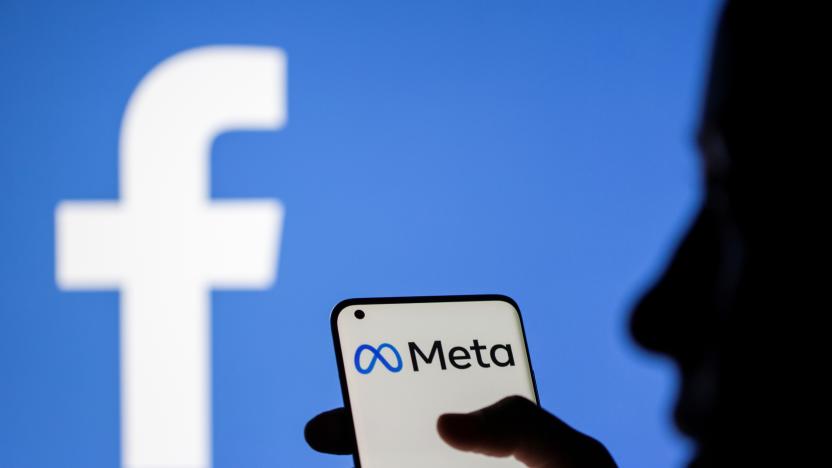 A woman holds a smartphone with Meta logo on it in front of a displayed Facebook logo in this illustration taken, October 28, 2021. REUTERS/Dado Ruvic/Illustration