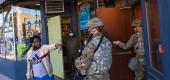 A business owner talks with members of the National Guard in Minneapolis (Getty)