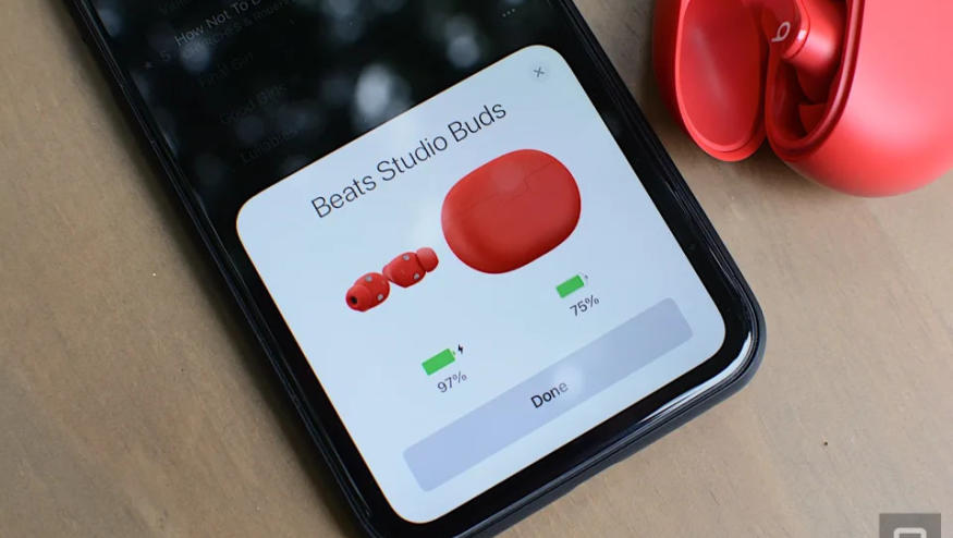 Beats Studio Buds in red pairing with a phone