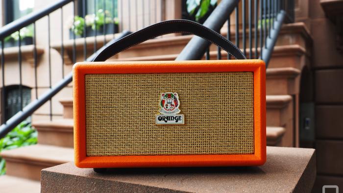 The Orange Amps - Orange Box Bluetooth speaker seen on the stoop of a brownstone, showing the front grille.
