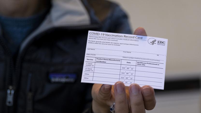 Sarah Gonzalez of New York, a Nurse Practitioner, displays a COVID-19 vaccine card at a New York Health and Hospitals vaccine clinic in the Brooklyn borough of New York Sunday, Jan. 10, 2021. The clinic, serving 30 people getting vaccines Sunday, will expand to a twenty four hour, seven days a week operation starting Monday. (AP Photo/Craig Ruttle)