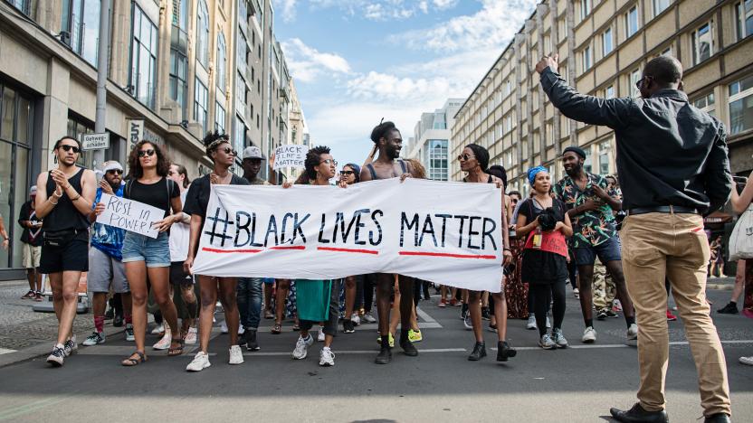 Demonstrators held a banner with the motto of the black civil rights movement with the twitter hashtag "#Black Lives Matter" to show their solidarity worldwide with African Americans in the US in Berlin, Germany, 10 July 2016. In the US, there were nationwide protests after the death of two African American by police shots. On the night of Friday 07 July 2016 the situation escalated. A sniper shot dead five police and injured two civilians during a demonstration against police violence in Dallas, Texas. Photo: WOLFRAM KASTL/dpa | usage worldwide   (Photo by Wolfram Kastl/picture alliance via Getty Images)