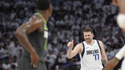 Associated Press - Dallas Mavericks guard Luka Doncic (77) celebrates his score as Minnesota Timberwolves guard Anthony Edwards, left, looks on during the first half of Game 5 of the Western Conference finals in the NBA basketball playoffs, Thursday, May 30, 2024, in Minneapolis. (AP Photo/Abbie Parr)