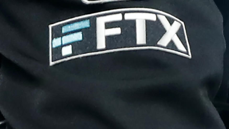 FILE - The FTX logo appears on home plate umpire Jansen Visconti's jacket at a baseball game with the Minnesota Twins on Sept. 27, 2022, in Minneapolis. Failed cryptocurrency exchange FTX says that nearly all of its customers will receive the money back that they are owed, and some will get more than that, according to its reorganization plan. FTX said in a court filing Tuesday, May 7, 2024 that it owes about $11.2 billion to its creditors. (AP Photo/Bruce Kluckhohn, File)