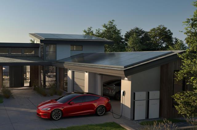 A house with solar panels on the roof. In front of the garage door is a red Tesla plugged into an outlet. White Powerwall units are visible on the outside wall of the garage.