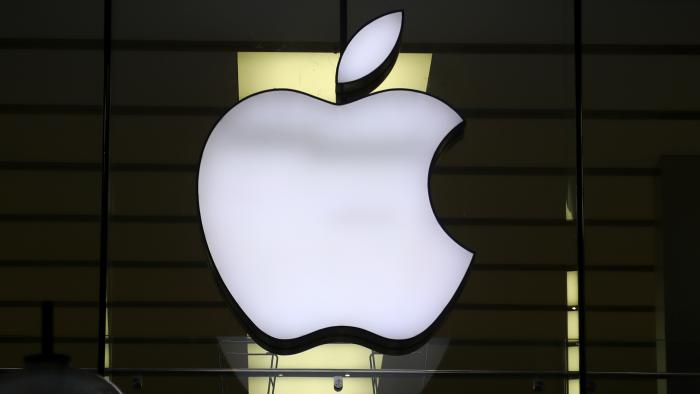 FILE - The logo of Apple is illuminated at a store in the city center in Munich, Germany, on Dec. 16, 2020. The European Union says it's accepting Apple's pledge to open up its tap-and-go mobile payment system to rivals as a way to resolve an antitrust case and head off a hefty fine. (AP Photo/Matthias Schrader, File)