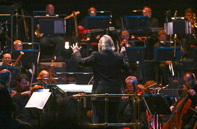 LONDON, ENGLAND - OCTOBER 04: Composer Nicholas Dodd performs on stage accompanied by The Royal Philharmonic Concert Orchestra during The Sound of 007 in concert at The Royal Albert Hall on October 04, 2022 in London, England. 