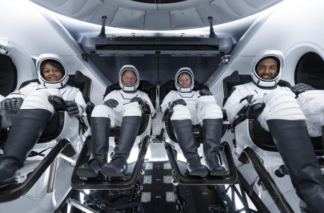 A group photo of the Axiom Mission 2 crew aboard a SpaceX Crew Dragon. From left to right, the astronauts are Rayyanah Barnawi, John Shoffner, Peggy Whitson and Ali Alqarni.