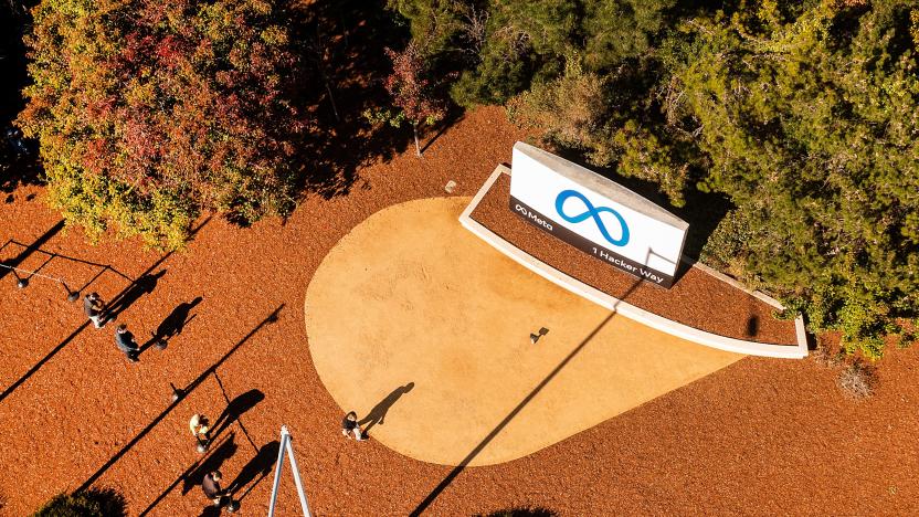 An aerial view shows a person passing a newly unveiled logo for "Meta", the new name for Facebook's parent company, outside Facebook headquarters in Menlo Park on October 28, 2021. - Facebook changed its parent company name to "Meta" on October 28 as the tech giant tries to move past being a scandal-plagued social network to its virtual reality vision for the future. (Photo by NOAH BERGER / AFP) (Photo by NOAH BERGER/AFP via Getty Images)