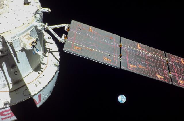 A photo of NASA's Orion crew vehicle, with the Earth in the background. 