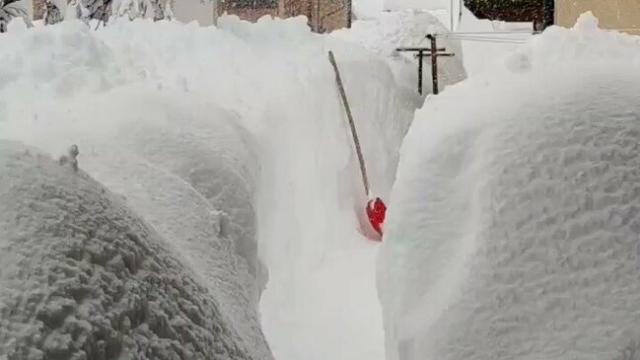 Resident Creates Path Through Deep Snow In Italian Town Of Sappada