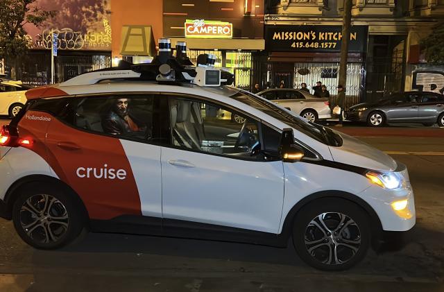 FILE - Associated Press reporter Michael Liedtke sits in the back of a Cruise driverless taxi that picked him up in San Francisco&#39;s Mission District, Feb. 15, 2023. California&#39;s Department of Motor Vehicles on Tuesday, Oct. 24, immediately suspended operation of Cruise&#39;s driverless robotaxis in San Francisco, citing public safety after one of its cars ran over a person fatally struck by a vehicle driven by a human. (AP Photo/Terry Chea, File)