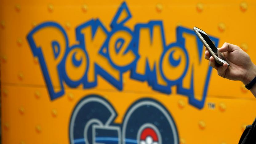 A man uses a mobile phone in front of an advertisement board bearing the image of Pokemon Go at an electronic shop in Tokyo, Japan, July 27, 2016.   REUTERS/Kim Kyung-Hoon/File Photo