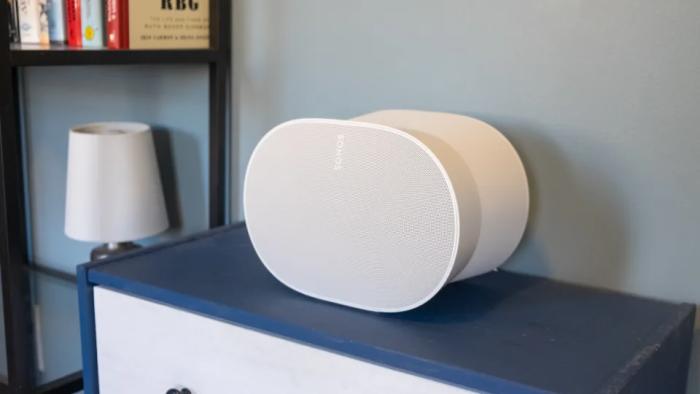 Photo of a white speaker on top of a blue cabinet.