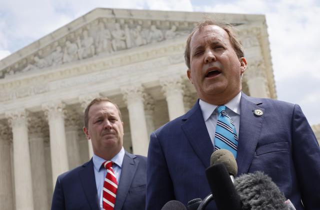 WASHINGTON, DC - APRIL 26: Texas Attorney General Ken Paxton (R) and Missouri Attorney General Eric Schmitt talk to reporters after the U.S. Supreme Court heard arguments in their case about Title 42 on April 26, 2022 in Washington, DC. Paxton and Schmitt, who is running for the U.S. Senate in Missouri, are suing to challenge the the Biden Administration's repeal of the Trump Migrant Protection Protocols—aka “Remain in Mexico.”  (Photo by Chip Somodevilla/Getty Images)