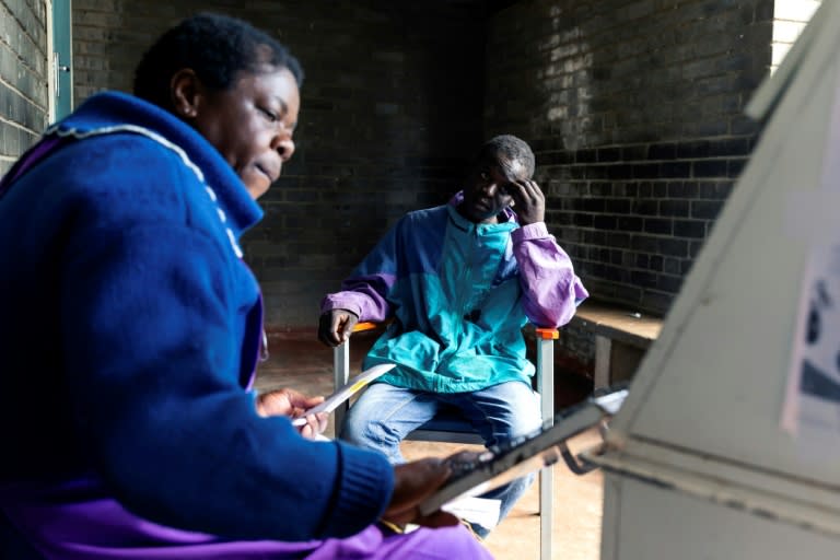 Blessing Chingwaru, an HIV positive and TB patient, has a consultation with a nurse at the Rutsanana clinic (AFP Photo/Jekesai NJIKIZANA)