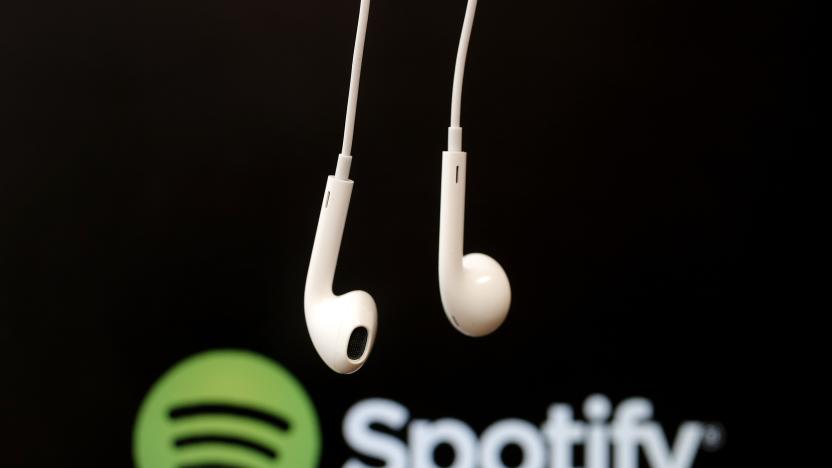 Headphones are seen in front of a logo of online music streaming service Spotify in this illustration picture taken in Strasbourg, February 18, 2014. Spotify is recruiting a U.S. financial reporting specialist, adding to speculation that the Swedish start-up is preparing for a share listing, which one banker said could value the firm at as much as $8 billion. REUTERS/Christian Hartmann (FRANCE - Tags: BUSINESS ENTERTAINMENT LOGO)