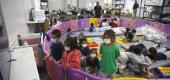 Young unaccompanied migrants, from ages 3 to 9, watch television inside a playpen at the U.S. Customs and Border Protection facility in Donna, Texas. (AP)