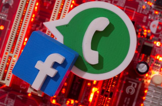3D printed Whatsapp and Facebook logos are placed on a computer motherboard in this illustration taken January 21, 2021. REUTERS/Dado Ruvic/Illustration