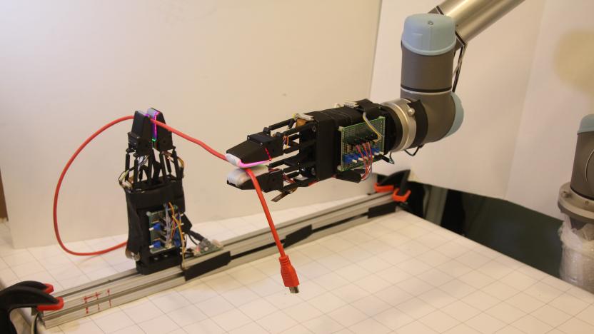 A picture of MIT's new robot handling a USB cable.