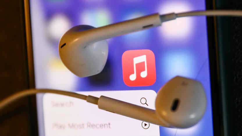 Apple Music icon displayed on a phone and headphones are seen in this illustration photo taken in Krakow, Poland on August 22, 2022. (Photo by Jakub Porzycki/NurPhoto via Getty Images)
