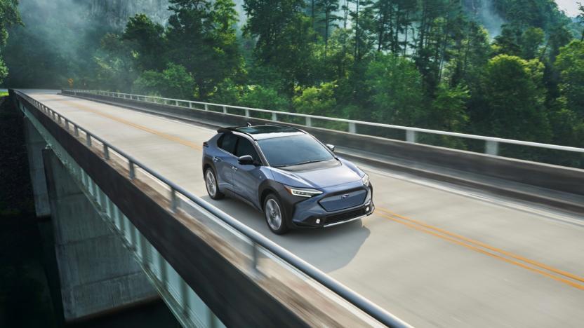 Subaru's Solterra EV driving across a bridge.