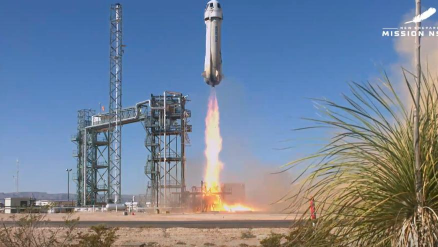 New Shepard rocket lifts off from the launch pad
