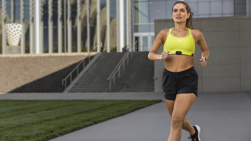 A person runs with the HRM-Fit attached to their sports bra. 