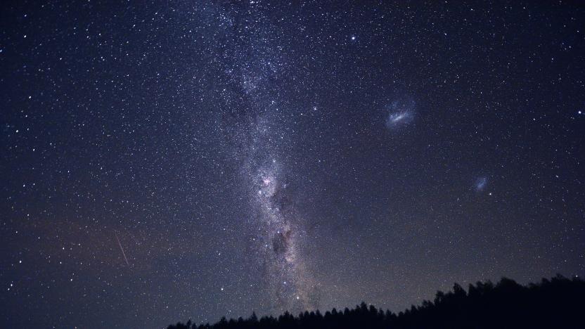 TOPSHOT - A tent is seen between trees as the Milky Way appears in the sky in the Uruguayan countryside some 185 km north of Montevideo near Capilla del Sauce, Florida Department, on February 5, 2021. (Photo by Mariana SUAREZ / AFP) (Photo by MARIANA SUAREZ/AFP via Getty Images)