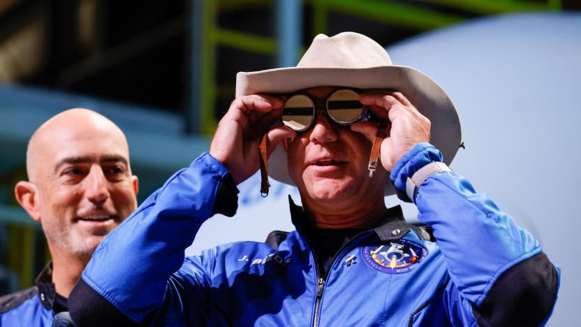 Billionaire American businessman Jeff Bezos wears goggles owned by Amelia Earhart which he carried into space at a post-launch press conference after he flew on Blue Origin's inaugural flight to the edge of space, in the nearby town of Van Horn, Texas, U.S., July 20, 2021. Bezos' brother Mark is on the left. REUTERS/Joe Skipper