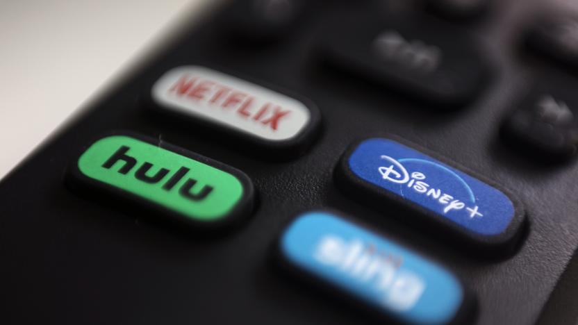 FILE - The logos for streaming services Netflix, Hulu, Disney Plus and Sling TV are pictured on a remote control on Aug. 13, 2020, in Portland, Ore. Walt Disney Co. said it will acquire a 33% stake in Hulu from Comcast for approximately $8.6 billion, a deal that will give Disney undisputed control of the streaming service. (AP Photo/Jenny Kane, File)